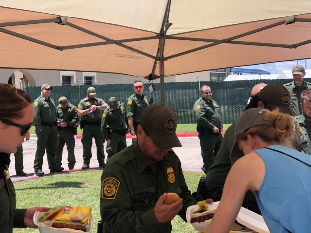 U.S. Border Patrol agents line up for burgers and hot dogs compliments of one of the mission teams working alongside City Church Del Rio in Del Rio, Texas.   This photo is being used for non-commercial purpose and not in connection with selling a good or service.